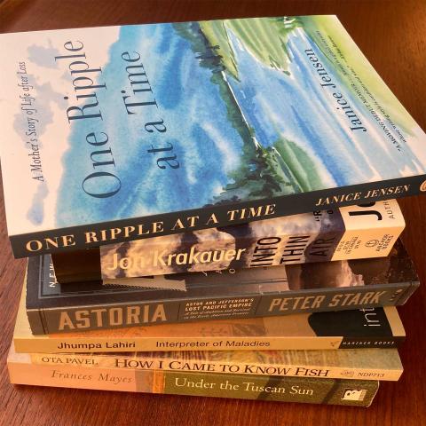 Stack of books to read, "One Ripple at a Time" by Janice Jensen on top